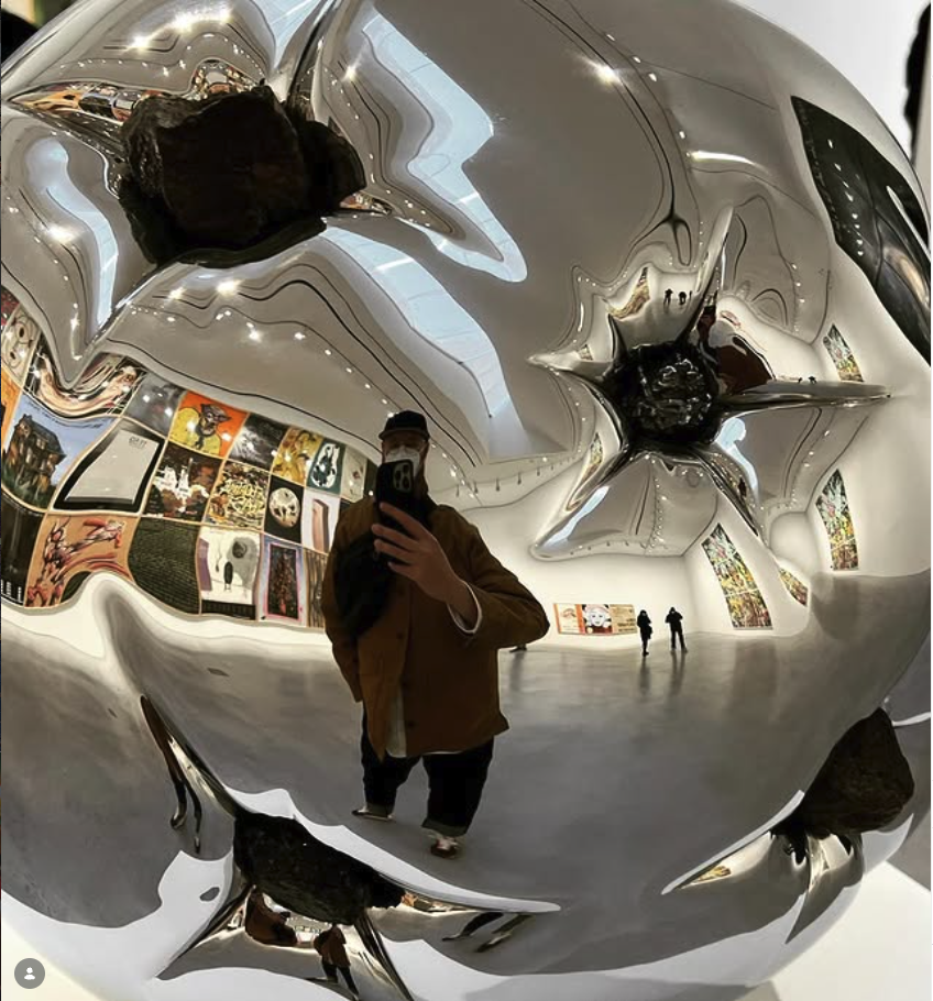 Reflection in a mirror-polished sculpture at a gallery