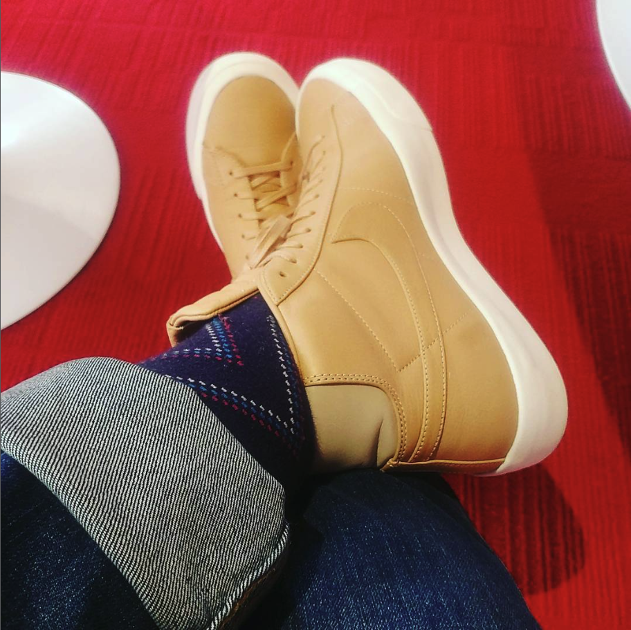 Tan leather high-top sneakers on red carpet