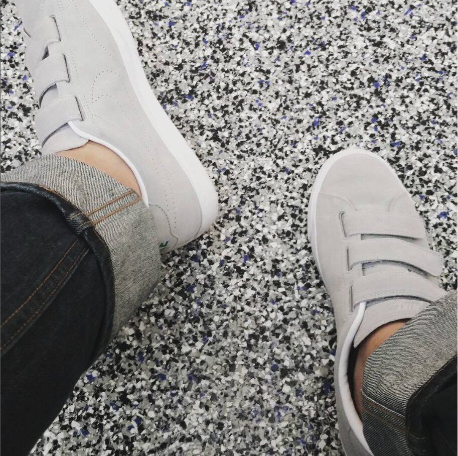 Cole Moir's sneakers on a terrazzo floor